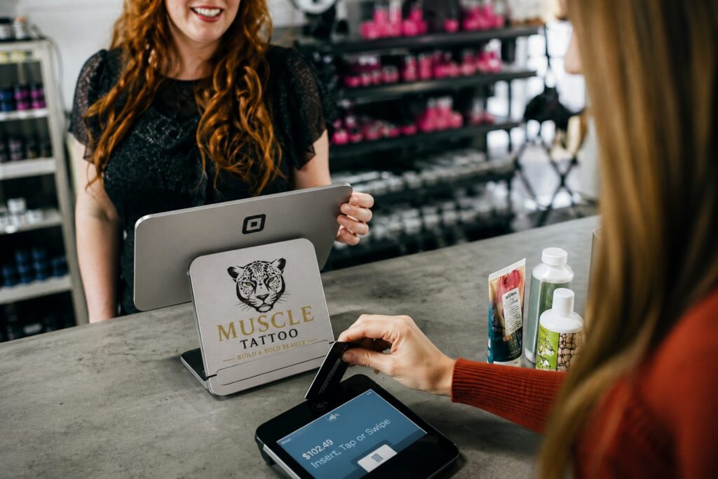 A customer inserts a credit card into a payment terminal at a checkout counter.